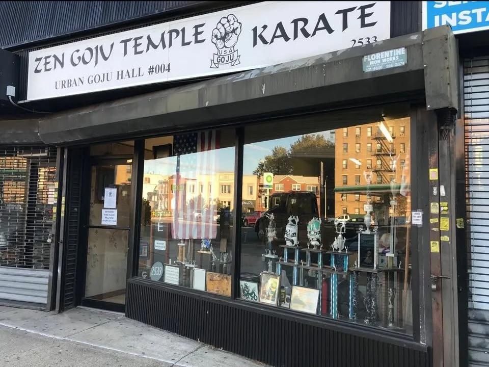 The dojo storefront on 65th Street with the gate up and the door open.